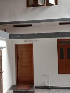 an empty room with a door and a wall at Kailas in Kollam