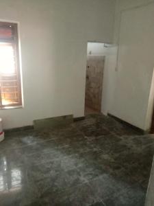 an empty room with a concrete floor and a window at Kailas in Kollam