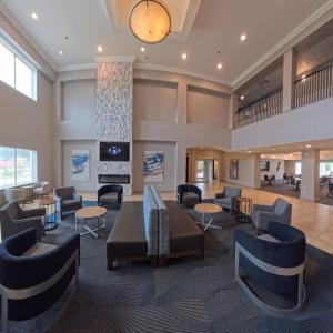 a lobby with couches and tables and a fireplace at La Quinta by Wyndham Longview North in Longview