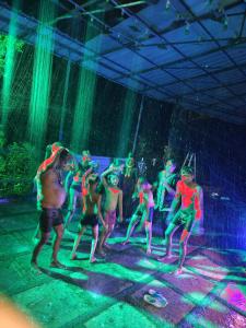 a group of people dancing in the rain at Grand Munnar Rooms in Munnar