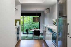 a kitchen with a table and a dining room at Saltus One bedroom- luxury and panoramic views in Hepburn Springs