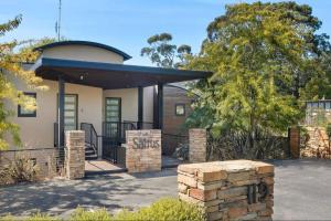 a house with a stone pillar in front of it at Saltus One bedroom- luxury and panoramic views in Hepburn Springs +5 photos