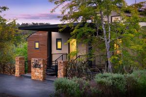 a small house with a black roof at Saltus One bedroom- luxury and panoramic views in Hepburn Springs