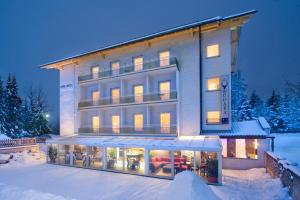 a large building in the snow at night at Park Hotel Gastein in Bad Hofgastein