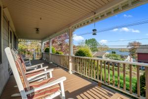 a porch with chairs and a view of the water at Grammy's Famous Lake House Retreat in East Hampton +35 photos