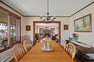 a dining room with a wooden table and chairs at Grammy's Famous Lake House Retreat in East Hampton