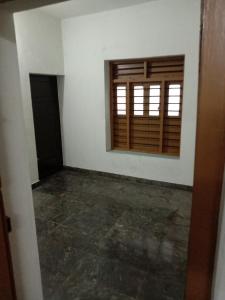 an empty room with a window and a concrete floor at Kailas in Kollam