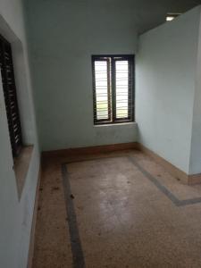 an empty room with a window and a floor at Kailas in Kollam