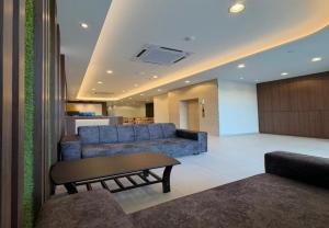 a living room with a couch and a table at Coastline Hotel 6 Avenue PortDickson in Port Dickson