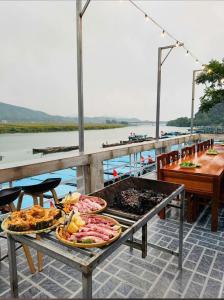 a table with many plates of food on it at Jade River Phong Nha in Phong Nha