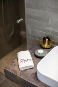 a towel on a counter next to a toilet in a bathroom at Gasthaus Stappen in Korschenbroich