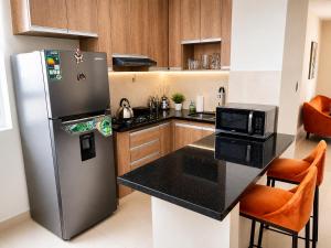 a kitchen with a refrigerator and a counter top at Tarija Premium Stay Apartamento Premium in Tarija