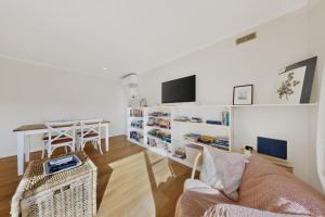 a living room with a couch and a table at Charming Guesthouse in Kyneton in Kyneton