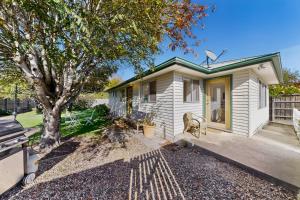 a small white house with a tree in front of it at Charming Guesthouse in Kyneton in Kyneton