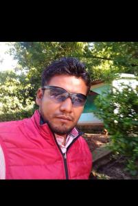a man wearing sunglasses and a red jacket at José Antonio in Xochitenco