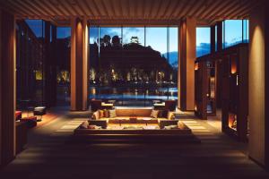 a living room with a couch and a large window at Hotel Indigo Inuyama Urakuen Garden by IHG in Inuyama