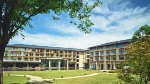 an exterior view of a building with a park at Hotel Indigo Inuyama Urakuen Garden by IHG in Inuyama