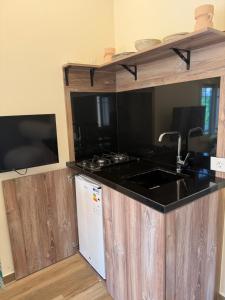 a kitchen with a sink and a counter top at Olvaya in Bzîza +14 photos
