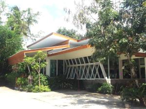 a house with trees in front of it at Baan Bangrak Residence in Trang
