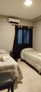 a hotel room with two beds and a window at Fran hotel boutique in Mendoza