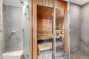 a walk in shower with a glass door at Victoria Sole & Mare with Sea View Terrace - Happy Rentals in Menton