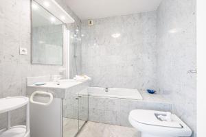 a white bathroom with a toilet and a sink at Victoria Sole & Mare with Sea View Terrace - Happy Rentals in Menton +21 photos
