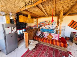 a living room with a couch and a refrigerator at Tizaou Guest House in Taghazout