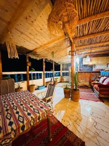 a large room with a bed and a couch at Tizaou Guest House in Taghazout