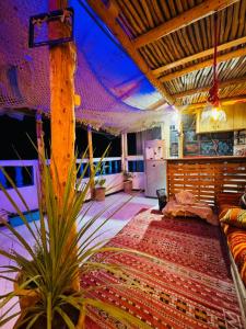 a living room with a couch and a table at Tizaou Guest House in Taghazout