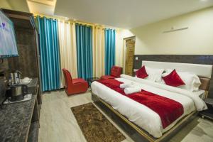 a bedroom with a large bed with a teddy bear on it at Naddi Mount #Atithi Devo Bhava #Free Parking-Mcleodganj 2 km- Bhagsunag 4 km in Dharamshala +4 photos