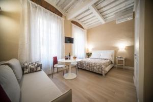 a bedroom with a bed and a table in a room at Apartments Lorenzo&Lorenzo in Florence