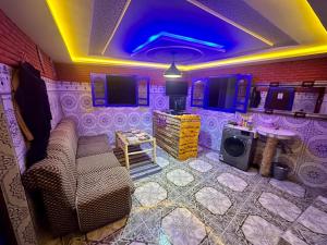 a living room with purple walls and a purple ceiling at Tizaou Guest House in Taghazout