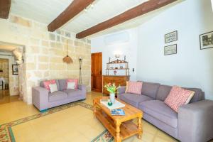 a living room with two couches and a coffee table at Il-Mohba Holiday Home in Munxar