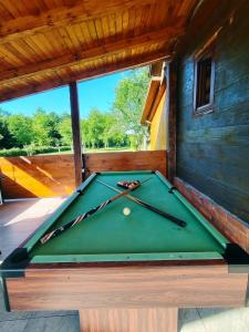 a green pool table sitting on a porch at Kuća za odmor Jopi i Mare in Topusko
