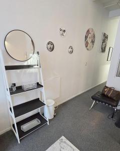 a room with a shelf and a mirror on the wall at Art Deco Chic on Queen in Auckland +17 photos