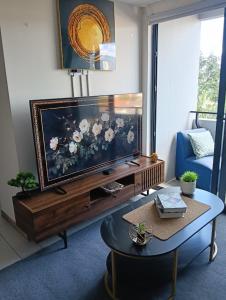 a living room with a large flat screen tv at Apartamento ignacio in Tegucigalpa +4 photos