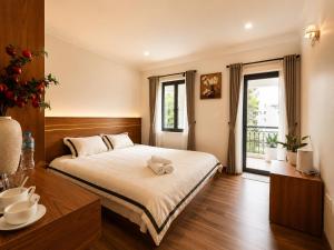 a bedroom with a bed with a towel on it at SaPa PAPA - Architect's Hidden Sanctuary - Only 4 rooms hidden in a secret botanical garden - 3 minutes from Sapa Station - Privacy & Privilege for stylish insiders in Sapa +25 photos