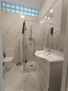 a white bathroom with a shower and a sink at Appartamento Turistico Monterotondo in Monterotondo +42 photos