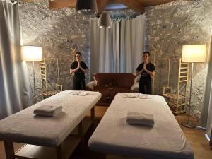 two men standing in a living room with two tables at Vinica Castle Boutique & Spa Hotel in Vinica