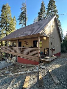 a house with a gambrel roof with a porch at Beautiful Sierra Mountain Cabin in Springville