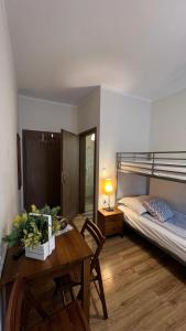 a room with a table and a bed and a bedroom at Eko Dworek tylko 1500m do wejścia Energylandii in Zator