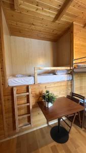 a room with a table and a bunk bed at Eko Dworek tylko 1500m do wejścia Energylandii in Zator