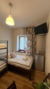 a bedroom with a bunk bed with a window at Eko Dworek tylko 1500m do wejścia Energylandii in Zator +47 photos