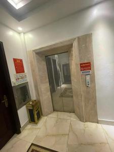 a bathroom with a shower with signs on the wall at Paloma Hotel Quan Lan in Quan Lạn