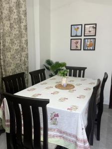 a dining room table with a table cloth on it at Cloud & Calm Homestay in Dharmsāla