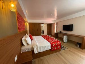 a hotel room with a bed and a television at The Pham Inn in Bomdila