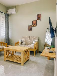 a living room with a couch and a table at SINDOM APARTMENTS Dodoma in Dodoma