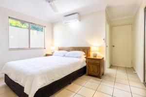 a bedroom with a large bed and a window at Eight, Villa Mar Colina in Yeppoon +8 photos
