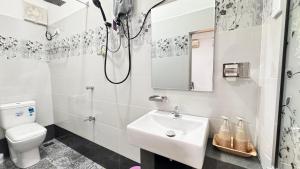 a white bathroom with a sink and a toilet at Air Route Transit in Seeduwa +19 photos