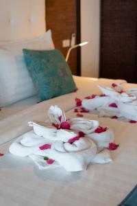 a group of folded towels on a bed at The Cosy New Appartement Fisherman in Bophut